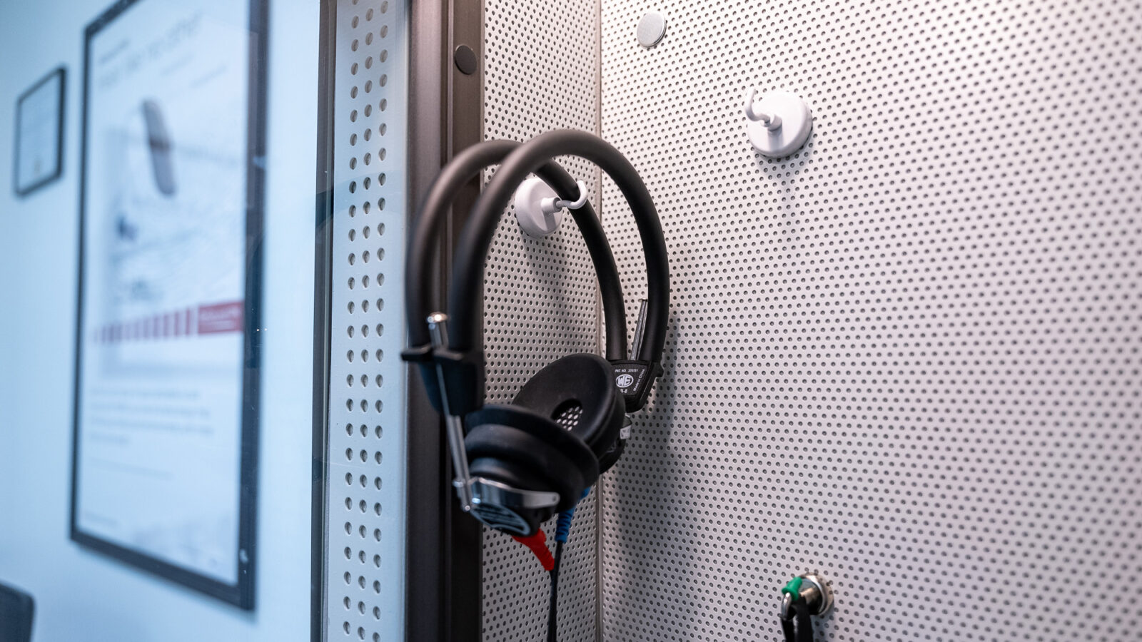 Audiometric headphones inside a sound booth